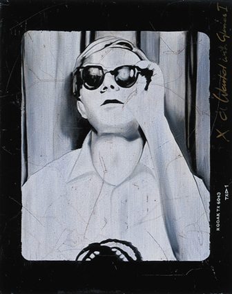 Andy Warhol putting on Glasses